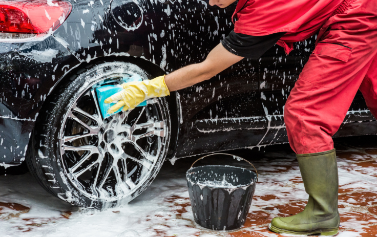 cleaning the rims of a black car